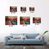 different sizes wall art painting depicting the beautiful sunset scenery of the Seine River in Paris hangs on the wall of the living room