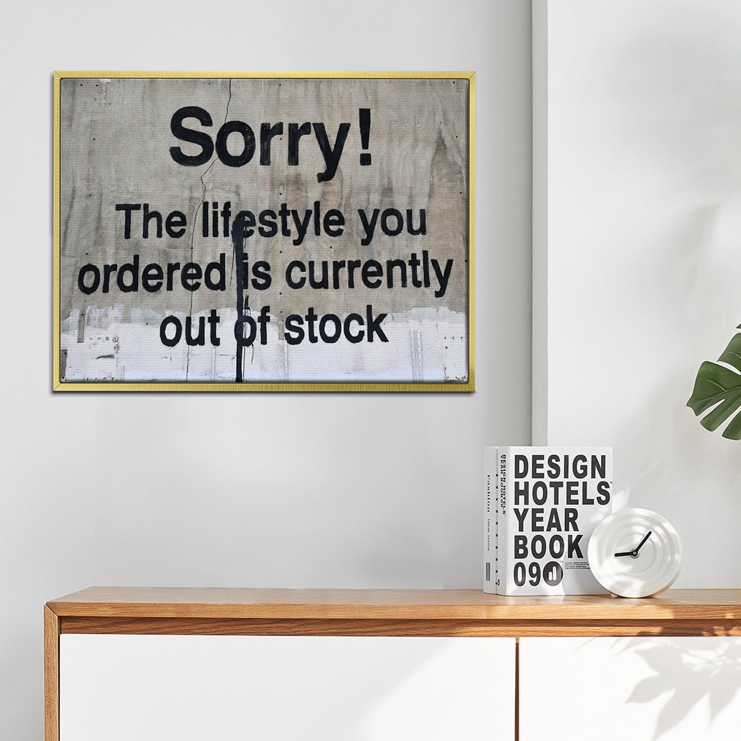 gold frame banksys statement canvas print hanging on the wall
