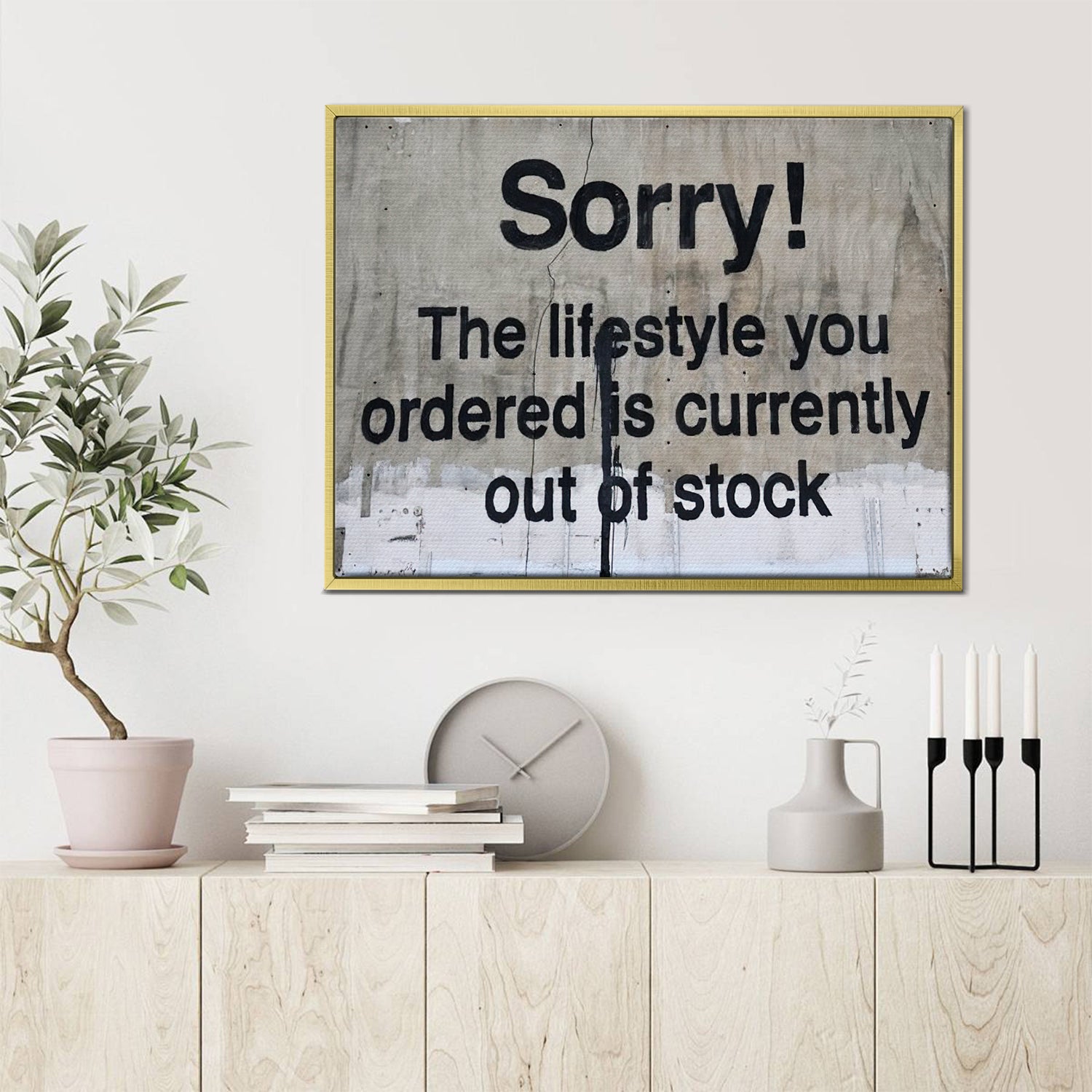 gold frame banksys statement canvas print hanging on the wall