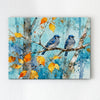 wall art canvas showing two bluebirds perched on a branch.