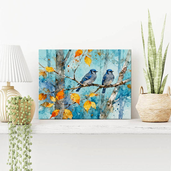 wall art canvas on the table showing two bluebirds perched on a branch.
