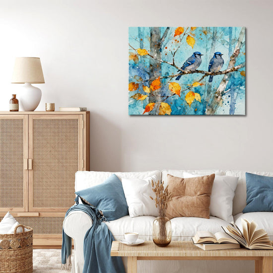 wall art canvas in the living room showing two bluebirds perched on a branch.