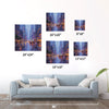 different size wall art painting showing the bustling city streets on a rainy night hangs on the wall of a warmly decorated room