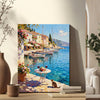 wall art canvas painting on the table showing a sunny seaside town with a table of red wine and flowers on the pier and a cat.