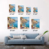 different size wall art canvas painting showing a sunny seaside town with a table of red wine and flowers on the pier and a cat.