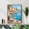 black frame wall art canvas painting showing a sunny seaside town with a table of red wine and flowers on the pier and a cat.
