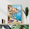 gold frame wall art canvas painting showing a sunny seaside town with a table of red wine and flowers on the pier and a cat.
