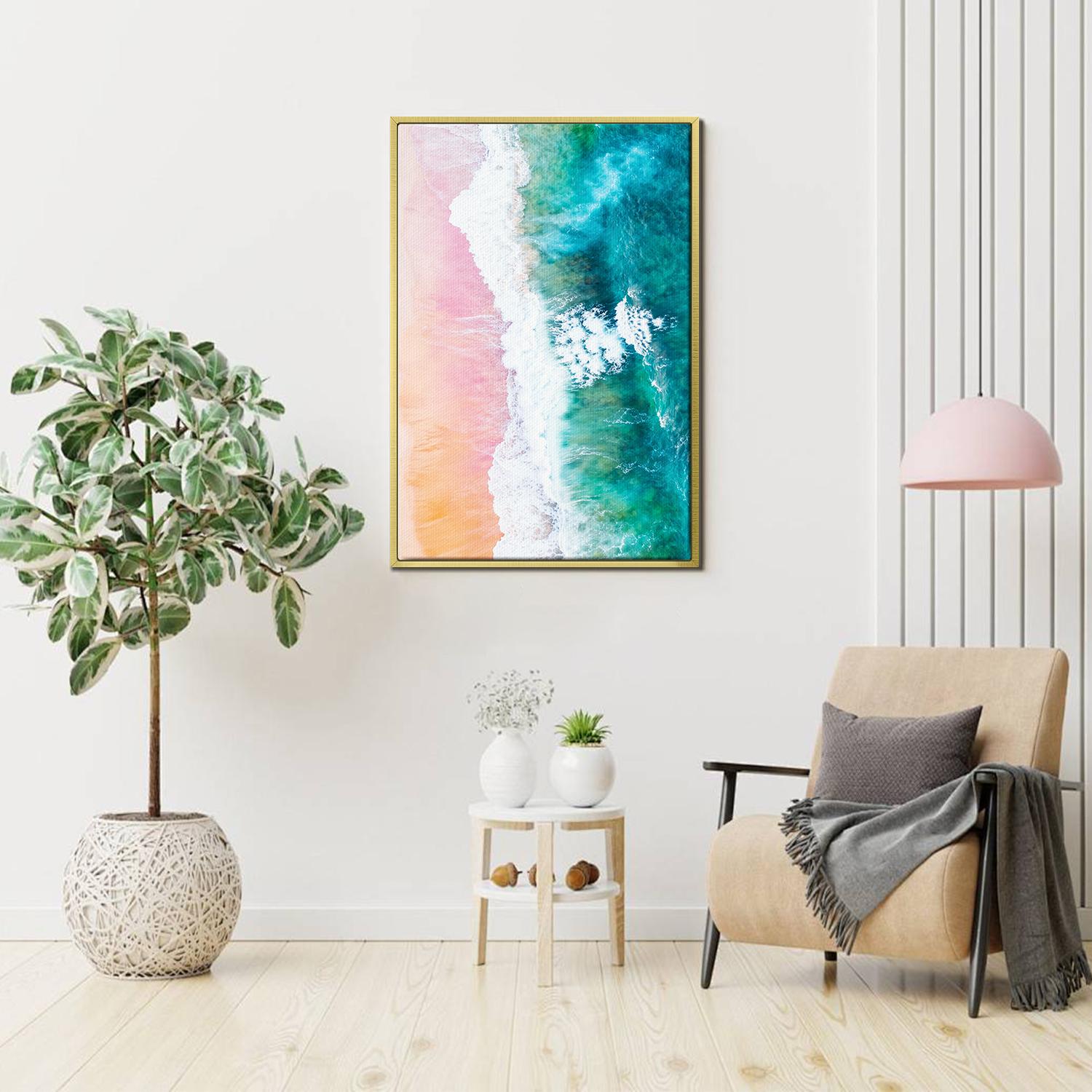 gold frame wall art canvas depicts pink sand beach and white waves