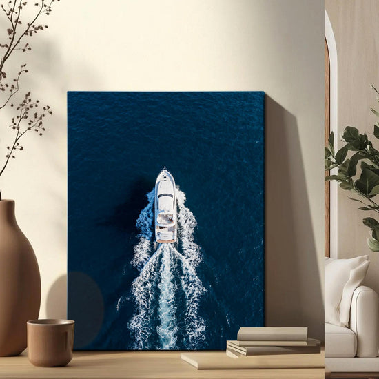 wall art canvas on the table depicts a white yacht sails on the deep blue sea
