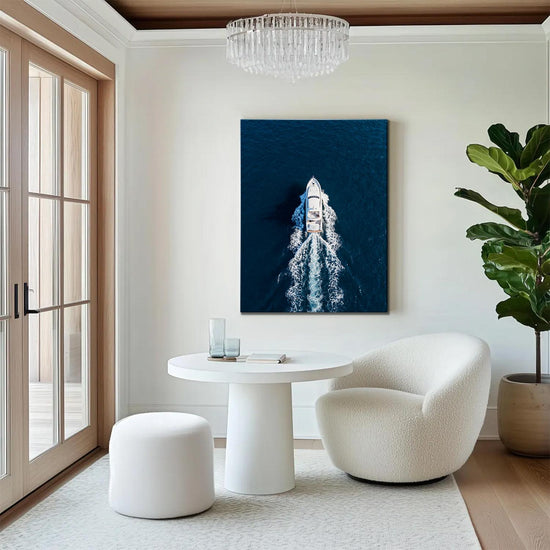 wall art canvas in the living room depicts a white yacht sails on the deep blue sea
