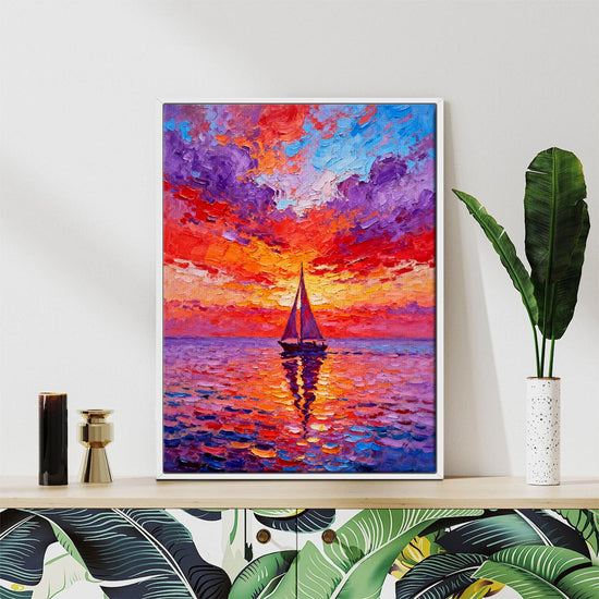 white frame wall art painting depicts the beautiful scenery of a sailboat sailing on the sea dyed by the gorgeous sunset.