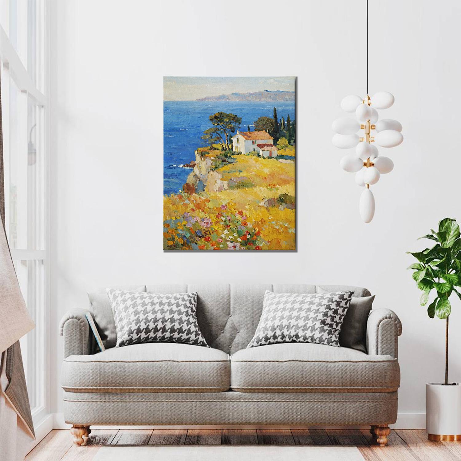 wall art painting in the living room depicting a cliffside cottage by the sea