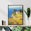 black frame wall art painting depicting a cliffside cottage by the sea