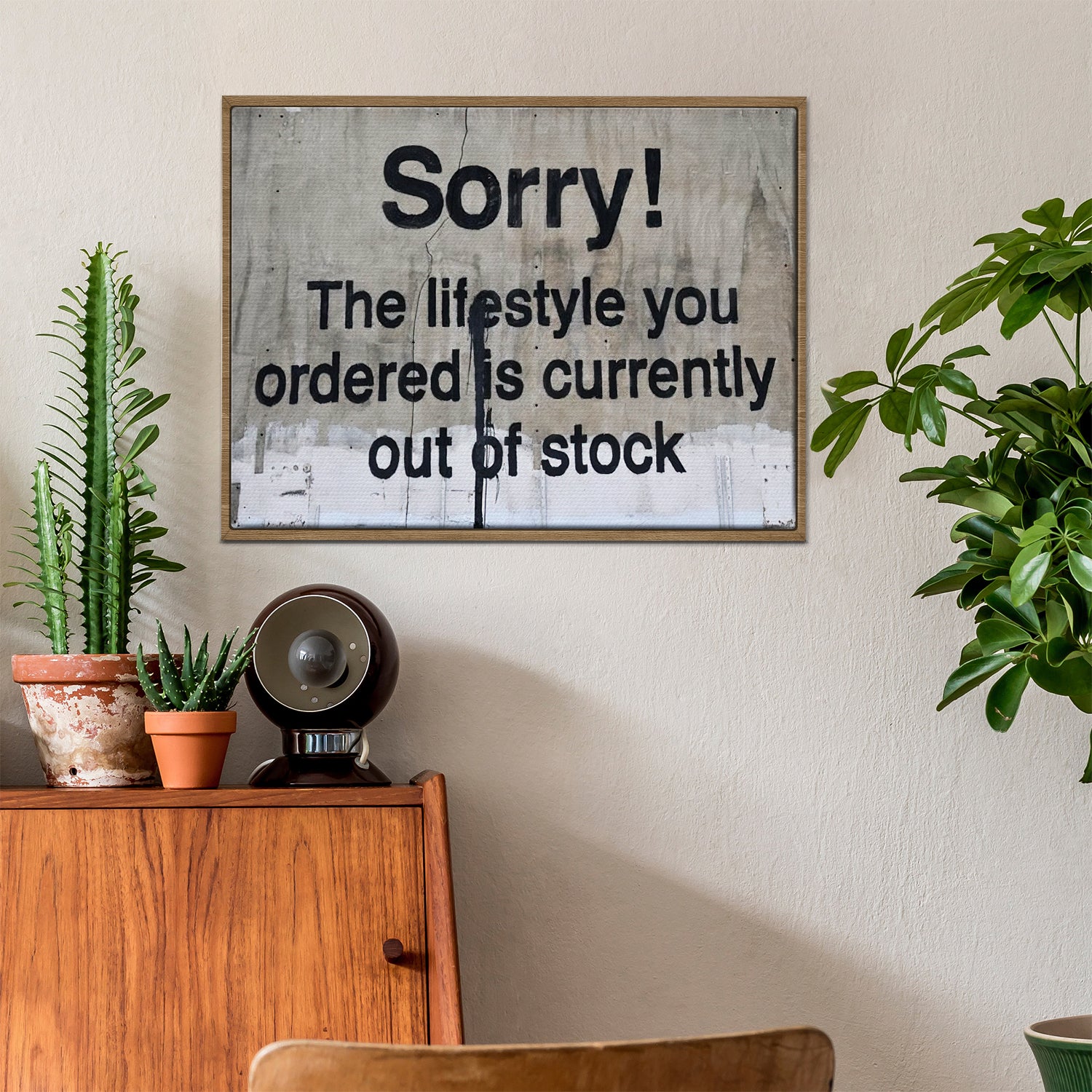 light oak color frame banksys statement canvas print in the living room