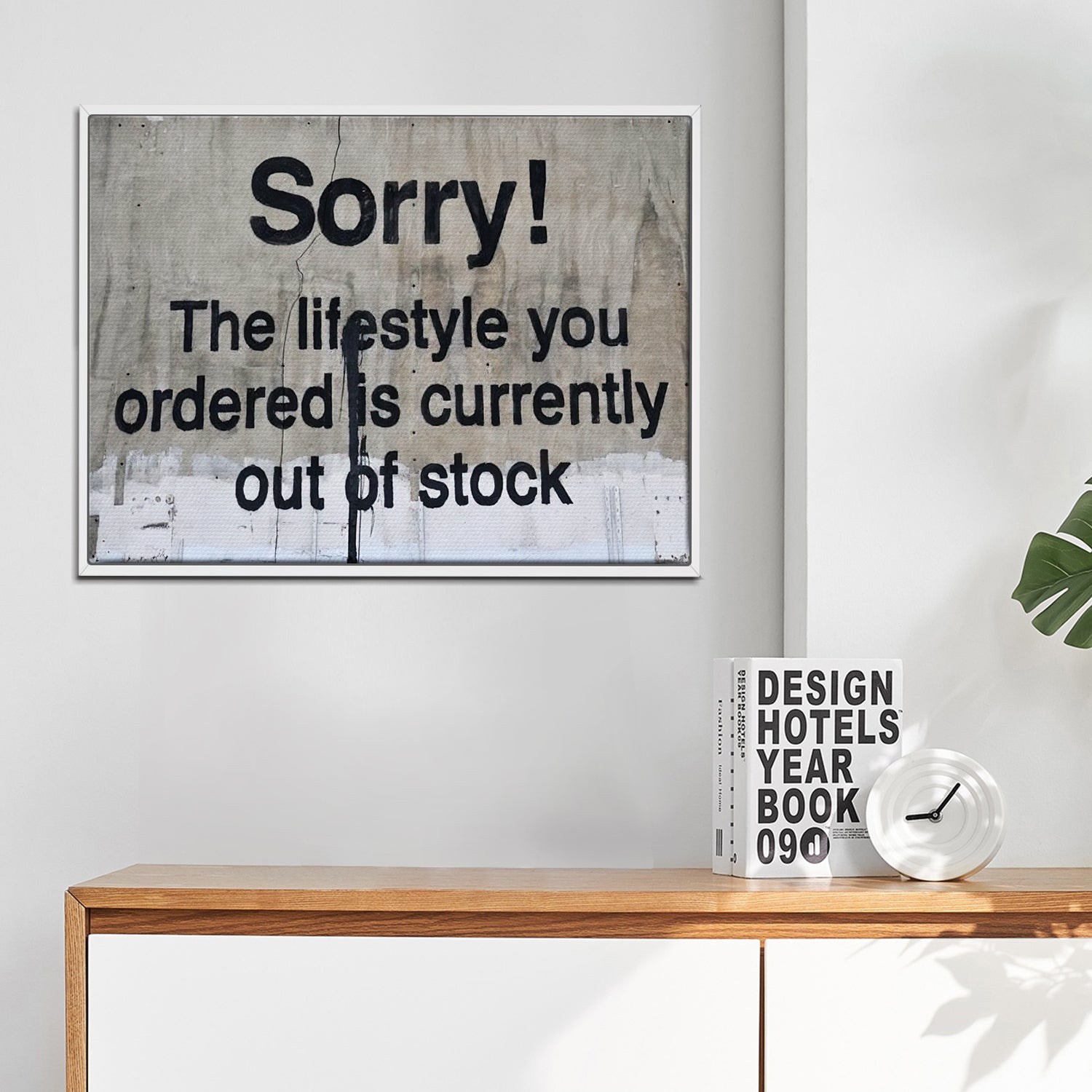 white frame banksys statement canvas print hanging on the wall