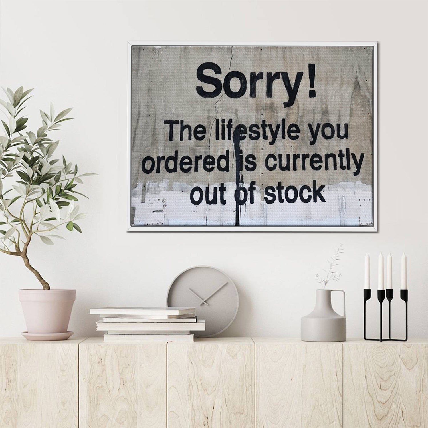 white frame banksys statement canvas print hanging on the wall