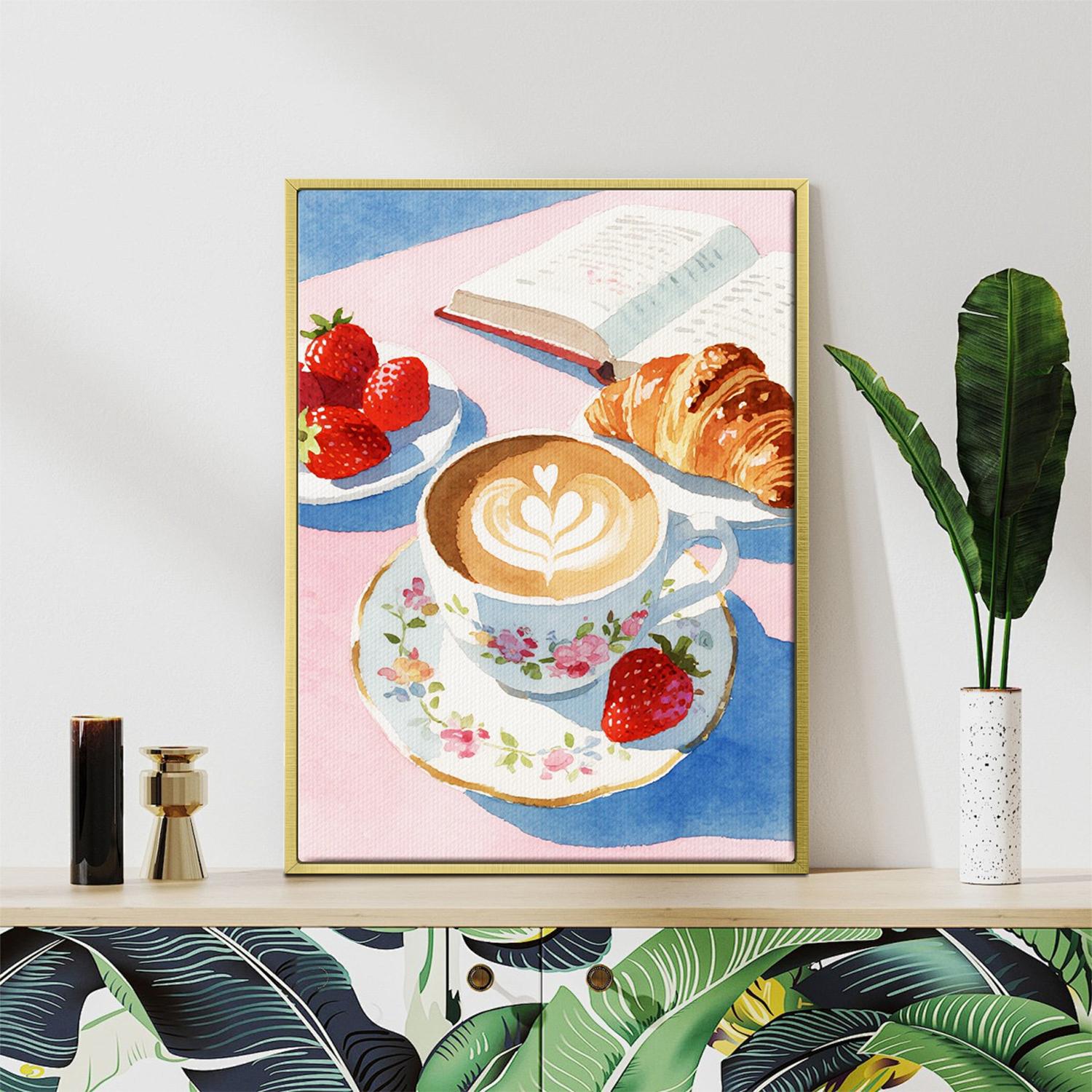 gold frame wall art canvas painting depicts a cozy scene with latte art coffee, strawberries, croissants and an open book.