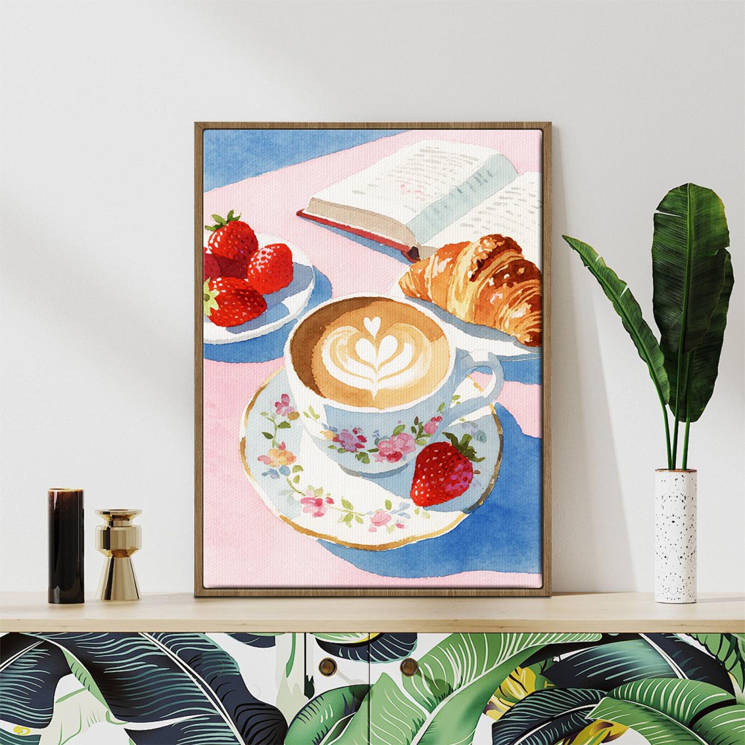 light oak color frame wall art canvas painting depicts a cozy scene with latte art coffee, strawberries, croissants and an open book.