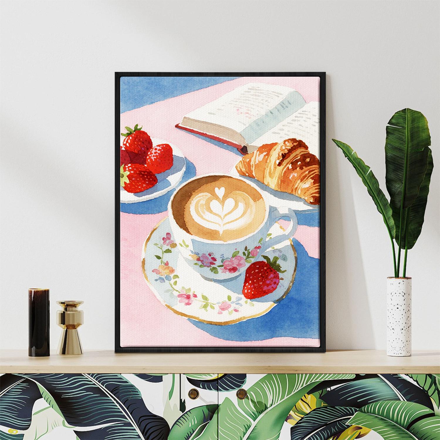 black frame wall art canvas painting depicts a cozy scene with latte art coffee, strawberries, croissants and an open book.