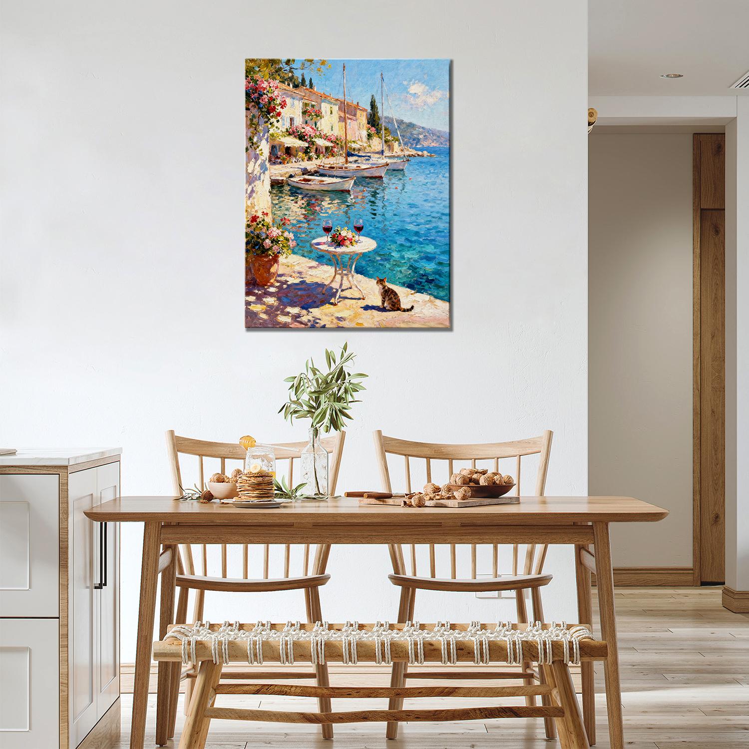 wall art canvas painting in the dining room showing a sunny seaside town with a table of red wine and flowers on the pier and a cat.