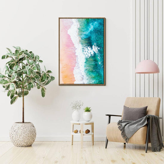light oak color frame wall art canvas depicts pink sand beach and white waves