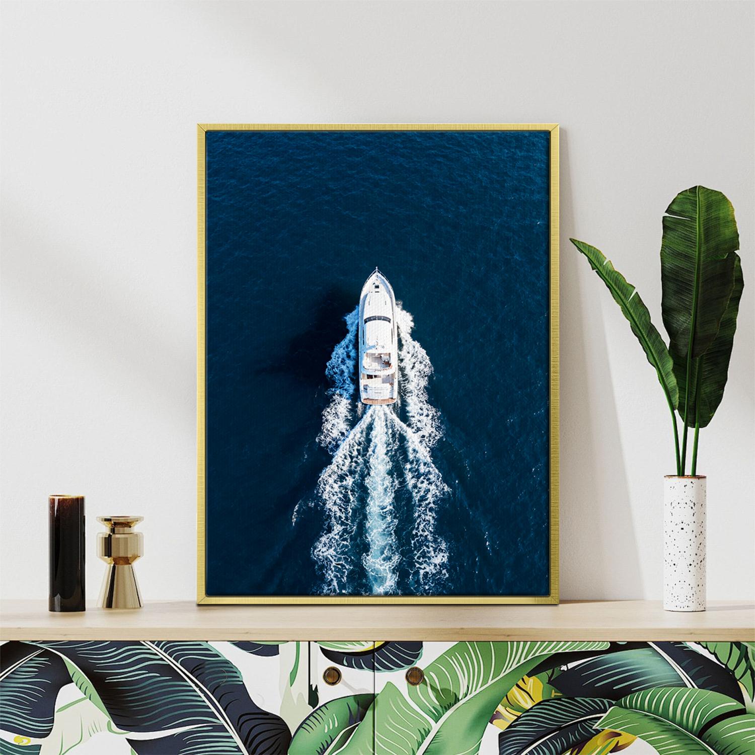 gold frame wall art canvas depicts a white yacht sails on the deep blue sea