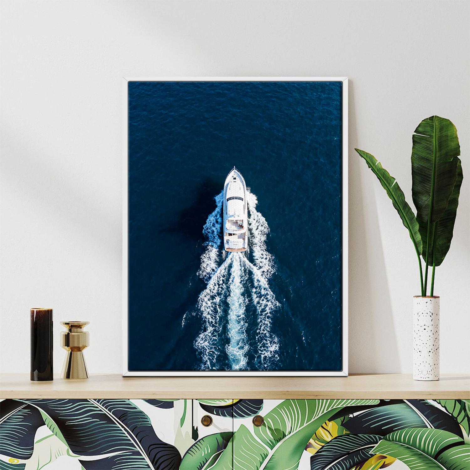 white frame wall art canvas depicts a white yacht sails on the deep blue sea